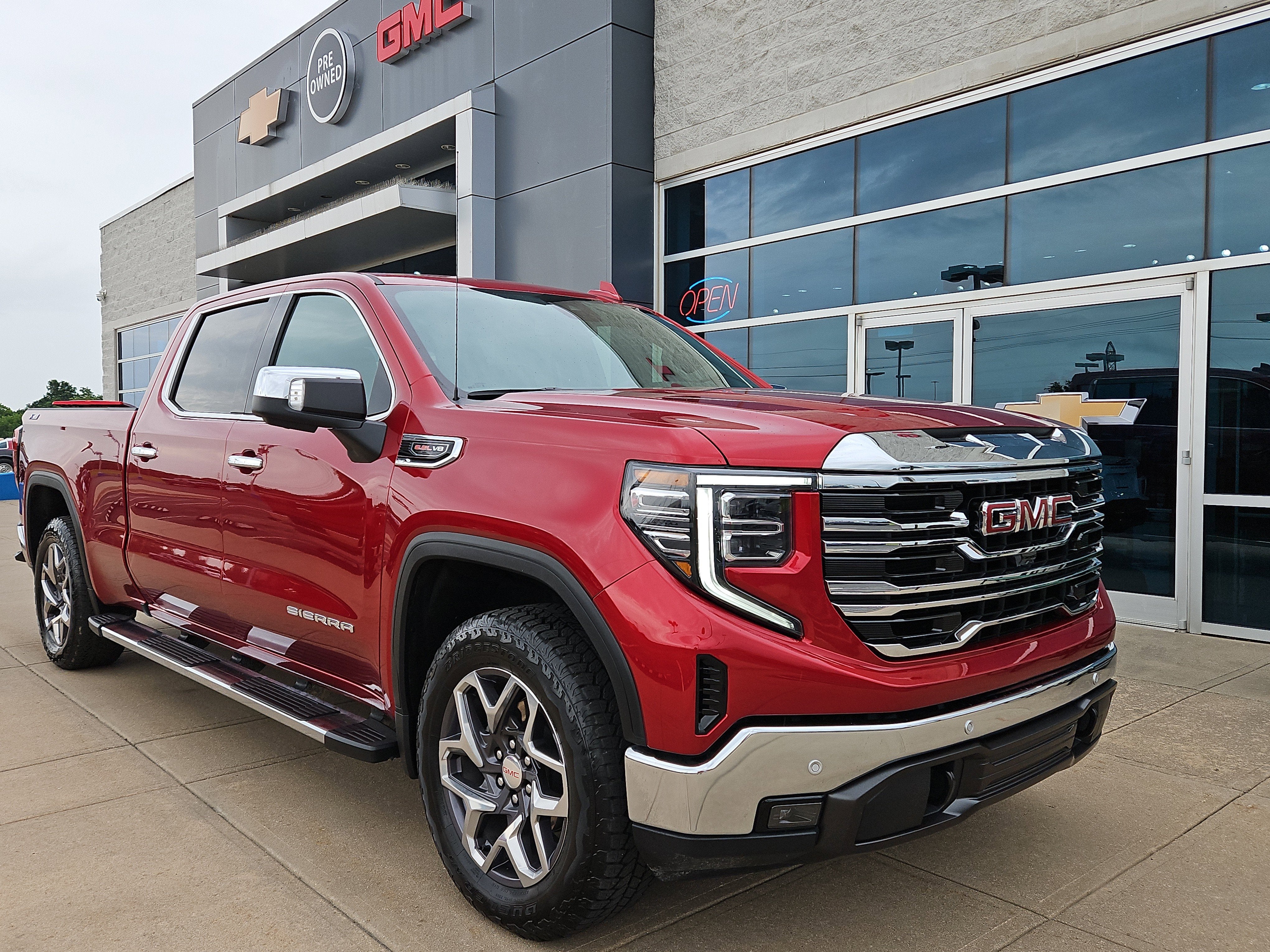 2024 GMC Sierra 1500 SLT in Volcanic Red Tintcoat — front three-quarter view